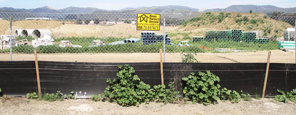 Cabrillo Village temporary fencing with debris netting at a construction site.